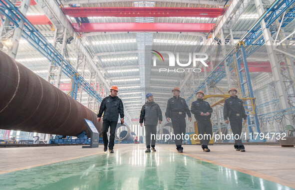 Police inspect an offshore wind power tower barrel manufacturing enterprise in Dongying City, East China, on November 20, 2024. 