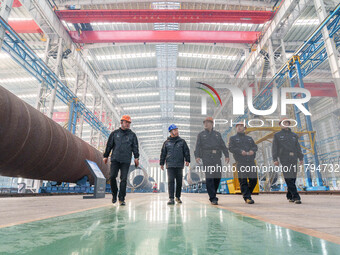 Police inspect an offshore wind power tower barrel manufacturing enterprise in Dongying City, East China, on November 20, 2024. (