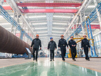 Police inspect an offshore wind power tower barrel manufacturing enterprise in Dongying City, East China, on November 20, 2024. (