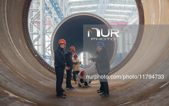 Police inspect an offshore wind power tower barrel manufacturing enterprise in Dongying City, East China, on November 20, 2024. 