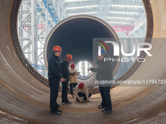 Police inspect an offshore wind power tower barrel manufacturing enterprise in Dongying City, East China, on November 20, 2024. (