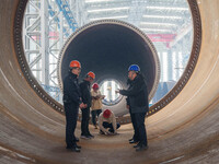 Police inspect an offshore wind power tower barrel manufacturing enterprise in Dongying City, East China, on November 20, 2024. (