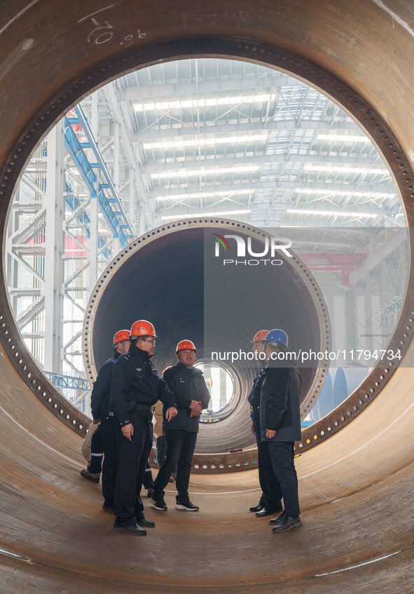 Police inspect an offshore wind power tower barrel manufacturing enterprise in Dongying City, East China, on November 20, 2024. 