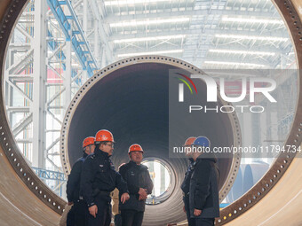 Police inspect an offshore wind power tower barrel manufacturing enterprise in Dongying City, East China, on November 20, 2024. (