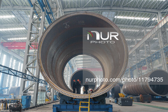 Police inspect an offshore wind power tower barrel manufacturing enterprise in Dongying City, East China, on November 20, 2024. 