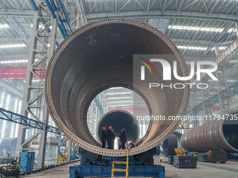 Police inspect an offshore wind power tower barrel manufacturing enterprise in Dongying City, East China, on November 20, 2024. (