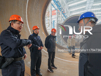 Police inspect an offshore wind power tower barrel manufacturing enterprise in Dongying City, East China, on November 20, 2024. (