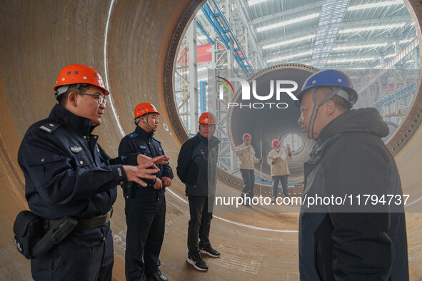 Police inspect an offshore wind power tower barrel manufacturing enterprise in Dongying City, East China, on November 20, 2024. 