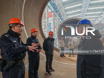 Police inspect an offshore wind power tower barrel manufacturing enterprise in Dongying City, East China, on November 20, 2024. (