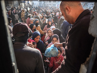 Palestinians wait in a queue to receive bread outside a bakery in Khan Yunis, on November 20, 2024, amid the ongoing war between Israel and...