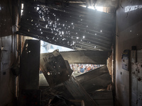 Palestinians wait in a queue to receive bread outside a bakery in Khan Yunis, on November 20, 2024, amid the ongoing war between Israel and...