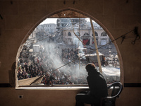 Palestinians wait in a queue to receive bread outside a bakery in Khan Yunis, on November 20, 2024, amid the ongoing war between Israel and...