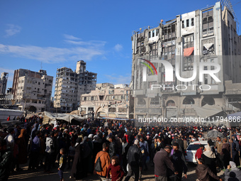 Palestinians wait in a queue to receive bread outside a bakery in Khan Yunis, on November 20, 2024, amid the ongoing war between Israel and...