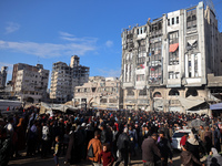 Palestinians wait in a queue to receive bread outside a bakery in Khan Yunis, on November 20, 2024, amid the ongoing war between Israel and...