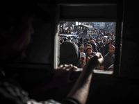 Palestinians wait in a queue to receive bread outside a bakery in Khan Yunis, on November 20, 2024, amid the ongoing war between Israel and...