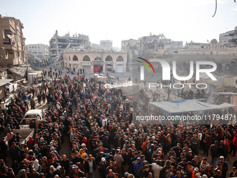 Palestinians wait in a queue to receive bread outside a bakery in Khan Yunis, on November 20, 2024, amid the ongoing war between Israel and...