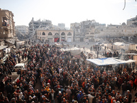 Palestinians wait in a queue to receive bread outside a bakery in Khan Yunis, on November 20, 2024, amid the ongoing war between Israel and...