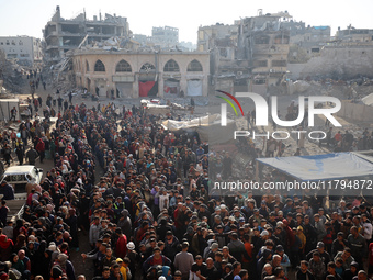 Palestinians wait in a queue to receive bread outside a bakery in Khan Yunis, on November 20, 2024, amid the ongoing war between Israel and...