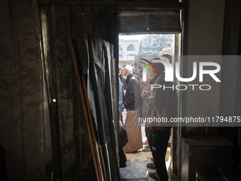 Palestinians wait in a queue to receive bread outside a bakery in Khan Yunis, on November 20, 2024, amid the ongoing war between Israel and...