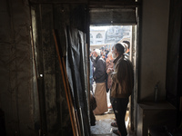 Palestinians wait in a queue to receive bread outside a bakery in Khan Yunis, on November 20, 2024, amid the ongoing war between Israel and...