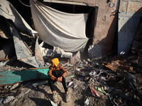 Palestinians wait in a queue to receive bread outside a bakery in Khan Yunis, on November 20, 2024, amid the ongoing war between Israel and...