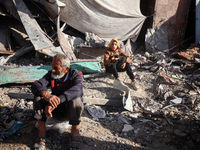 Palestinians wait in a queue to receive bread outside a bakery in Khan Yunis, on November 20, 2024, amid the ongoing war between Israel and...