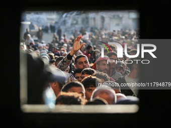 Palestinians wait in a queue to receive bread outside a bakery in Khan Yunis, on November 20, 2024, amid the ongoing war between Israel and...