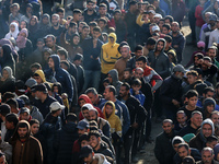 Palestinians wait in a queue to receive bread outside a bakery in Khan Yunis, on November 20, 2024, amid the ongoing war between Israel and...