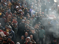 Palestinians wait in a queue to receive bread outside a bakery in Khan Yunis, on November 20, 2024, amid the ongoing war between Israel and...