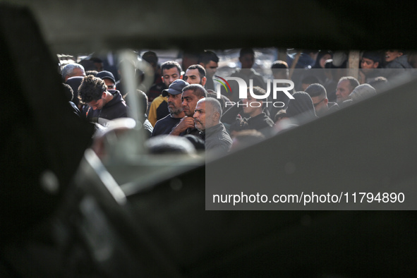 Palestinians wait in a queue to receive bread outside a bakery in Khan Yunis, on November 20, 2024, amid the ongoing war between Israel and...