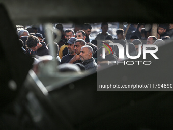 Palestinians wait in a queue to receive bread outside a bakery in Khan Yunis, on November 20, 2024, amid the ongoing war between Israel and...