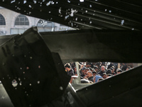 Palestinians wait in a queue to receive bread outside a bakery in Khan Yunis, on November 20, 2024, amid the ongoing war between Israel and...