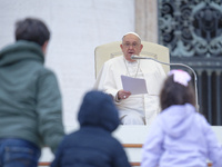 Pope Francis greets a group of children during his weekly general audience in St. Peter's Square at The Vatican, on November 20, 2024. (