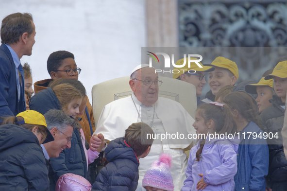 Pope Francis greets a group of children during his weekly general audience in St. Peter's Square at The Vatican, on November 20, 2024. 