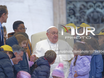 Pope Francis greets a group of children during his weekly general audience in St. Peter's Square at The Vatican, on November 20, 2024. (