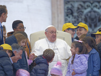 Pope Francis greets a group of children during his weekly general audience in St. Peter's Square at The Vatican, on November 20, 2024. (