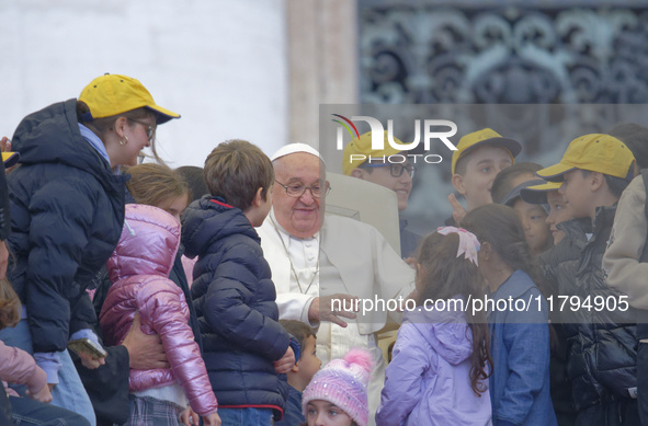 Pope Francis greets a group of children during his weekly general audience in St. Peter's Square at The Vatican, on November 20, 2024. 