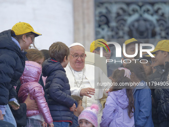 Pope Francis greets a group of children during his weekly general audience in St. Peter's Square at The Vatican, on November 20, 2024. (