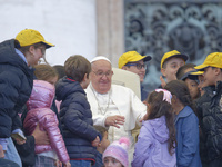 Pope Francis greets a group of children during his weekly general audience in St. Peter's Square at The Vatican, on November 20, 2024. (