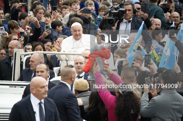 Pope Francis waves as he arrives for his weekly general audience in St. Peter's Square at The Vatican, on November 20, 2024. 