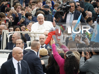 Pope Francis waves as he arrives for his weekly general audience in St. Peter's Square at The Vatican, on November 20, 2024. (