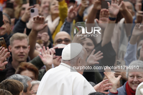 Pope Francis waves as he arrives for his weekly general audience in St. Peter's Square at The Vatican, on November 20, 2024. 