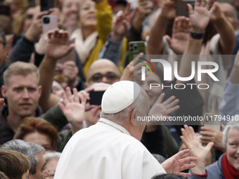 Pope Francis waves as he arrives for his weekly general audience in St. Peter's Square at The Vatican, on November 20, 2024. (