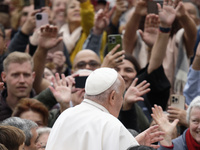 Pope Francis waves as he arrives for his weekly general audience in St. Peter's Square at The Vatican, on November 20, 2024. (