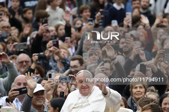 Pope Francis waves as he arrives for his weekly general audience in St. Peter's Square at The Vatican, on November 20, 2024. 