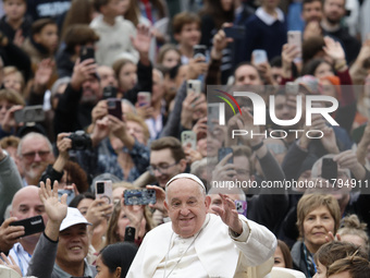 Pope Francis waves as he arrives for his weekly general audience in St. Peter's Square at The Vatican, on November 20, 2024. (