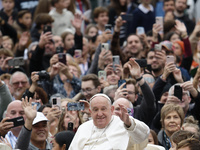 Pope Francis waves as he arrives for his weekly general audience in St. Peter's Square at The Vatican, on November 20, 2024. (