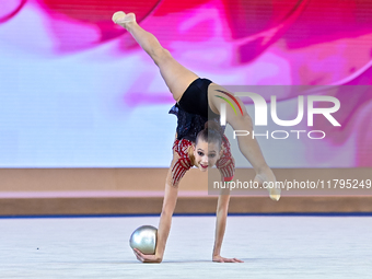 Marharyta Raksa of Belarus performs the ball exercise during the juniors apparatus finals of the International Rhythmic Gymnastics Tournamen...