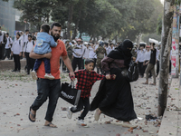 Commuters pass by a road during a clash in Dhaka, Bangladesh, on November 20, 2024. (