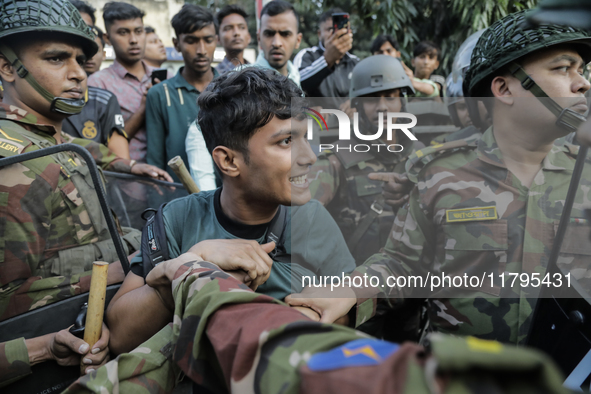 Bangladesh Armed Force personnel arrest picketers amid a clash in Dhaka, Bangladesh, on November 20, 2024. 